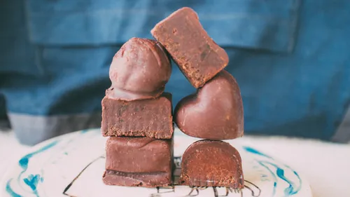 Chocolate truffles stacked on a plate.