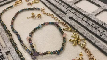 Jewelry beads on felt with ruler nearby.