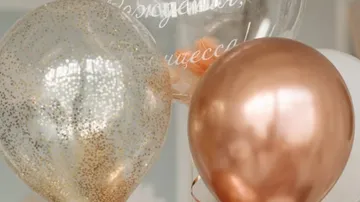 Metallic balloons floating in a room.