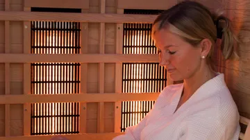 Woman relaxing in infrared sauna.