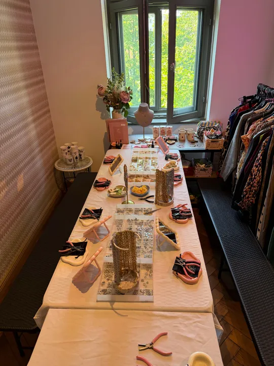 Craft table with tools and jewelry materials.