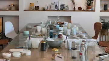 Craft supplies on a long table in studio.