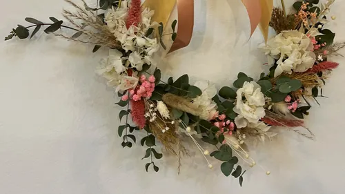 Floral wreath with pink and white flowers.