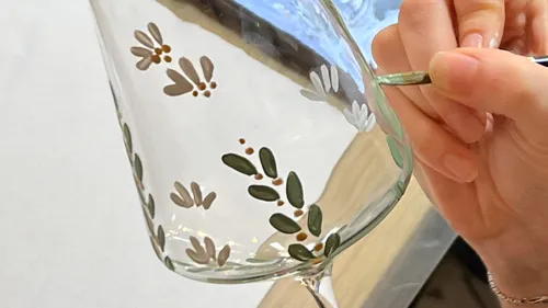 Hand painting flower design on wine glass.