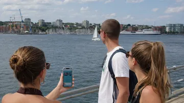 People looking at water with boats