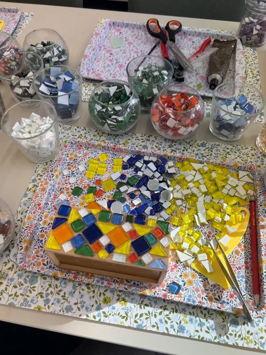 Colorful mosaic pieces on a crafting table.