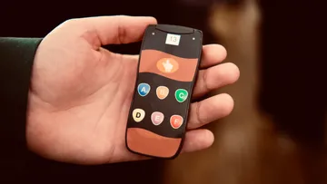 Hand holding a futuristic smartphone screen.
