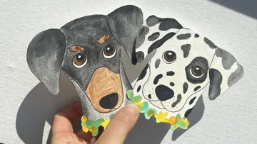 Zwei Cartoon-Hunde auf Papier.