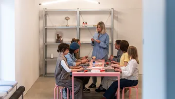 People crafting at a table indoors.