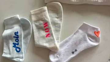 Colorful socks on white surface.