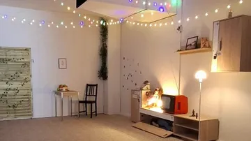 Cozy room with vintage decor and string lights.