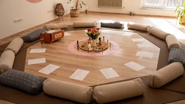 Circular seating for meditation in bright room.