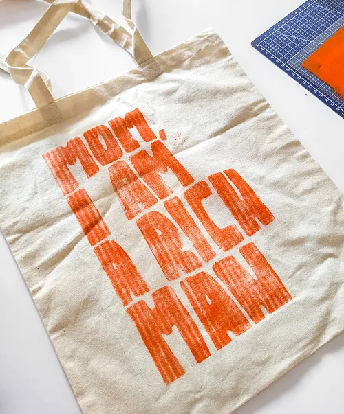 Tote bag with orange text design.