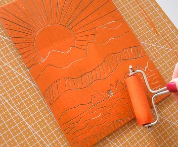 Linocut sun mountains roller art process.