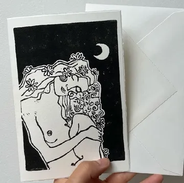 Black and white drawing, moonlit couple embracing.