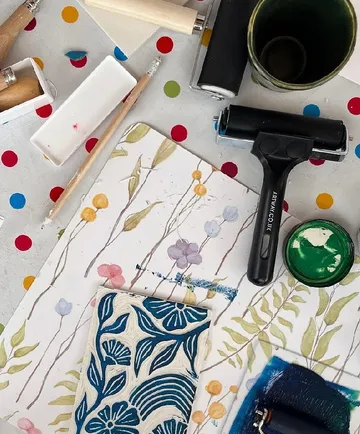 Art tools on colorful dotted table.
