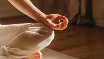 Person meditating in a calm room.