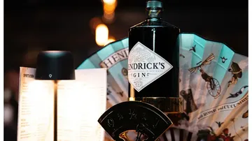 Hendrick's gin bottle in bar setting.