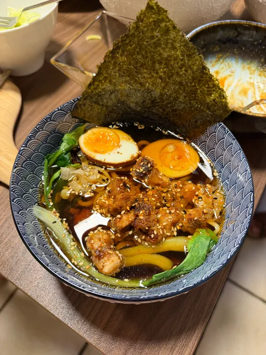 Bowl of ramen with egg and seaweed.