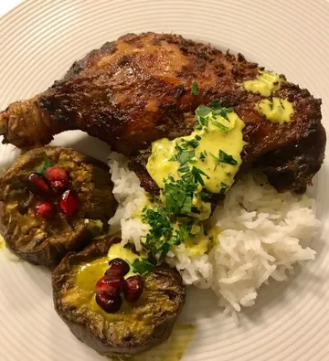 Grilled chicken with sauce over rice.