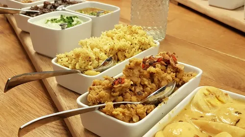 Assorted Indian dishes in white bowls.