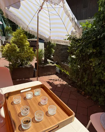Tray with condiment jars on outdoor table.