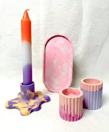 Colorful candleholder with candle and trays.