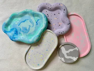 Colorful resin trays on white surface.