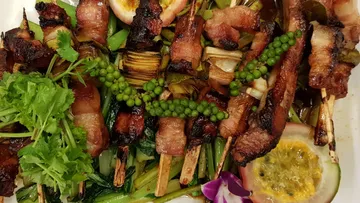 Gegrillte Spieße mit Kräutern und Garnierungen.
