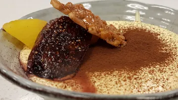 Dessert with fruit and chocolate garnish.
