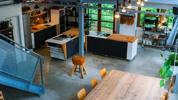 Modern kitchen with wooden dining table.