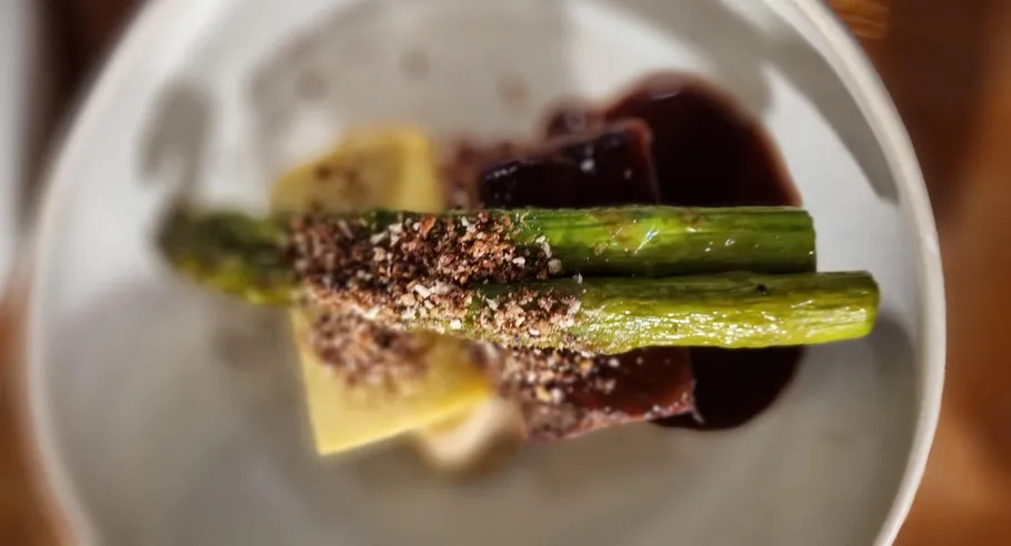 Asparagus on top of garnished dish.