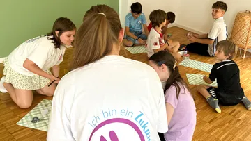 Children sitting on floor playing together.