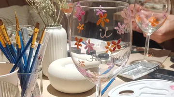 Painted wine glasses on a decorated table.