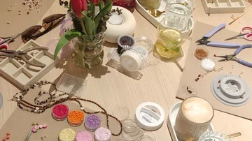 Crafting table with beads and tools.