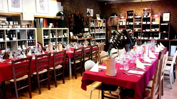Tables set for dining in a wine shop.