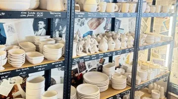Ceramic items displayed on shop shelves.