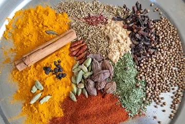 Assorted spices on a metal tray.