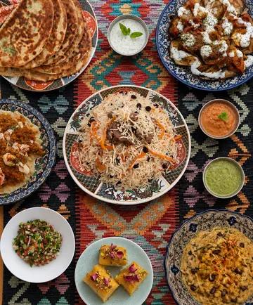 Variety of dishes on colorful table mat.