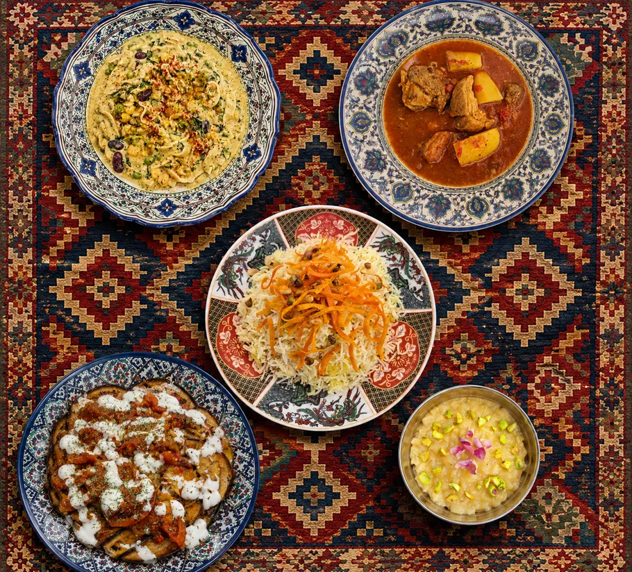 Five dishes arranged on a patterned rug.