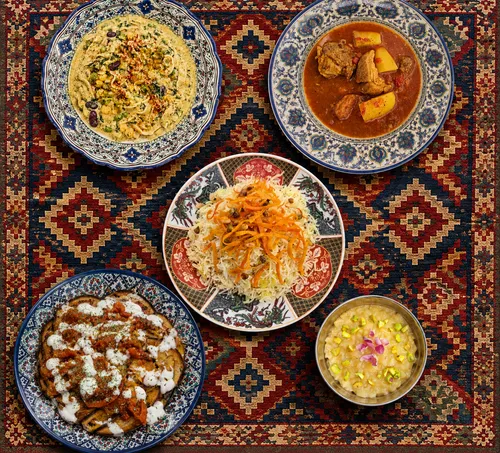 Five dishes arranged on ornate patterned cloth.