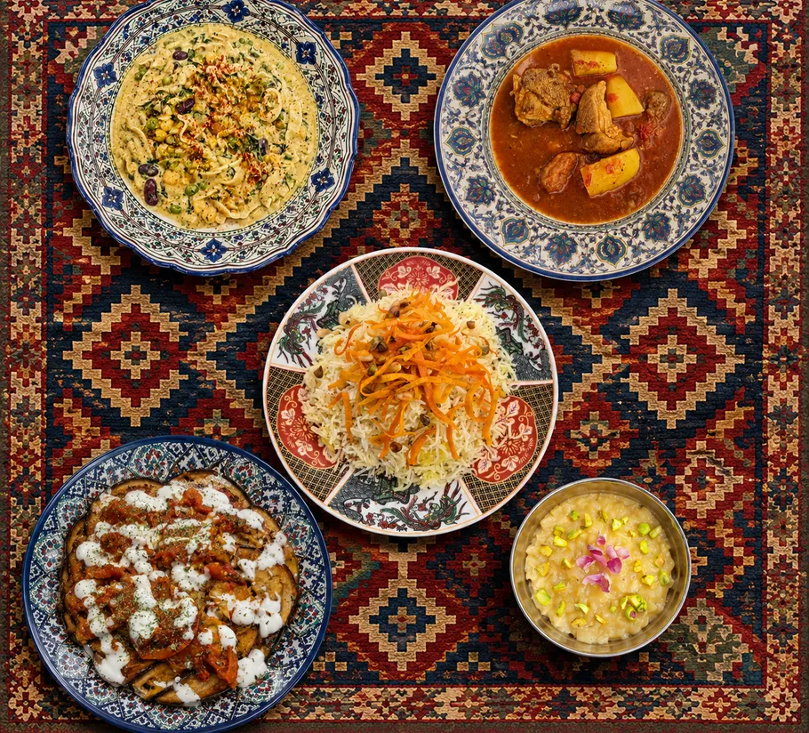Five dishes arranged on ornate patterned cloth.