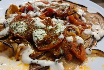 Roasted vegetables drizzled with sauce on plate