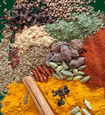 Whole and ground spices on green background.