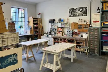 Art studio with desks and shelves.