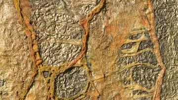 Abstract texture with gold and orange patterns.
