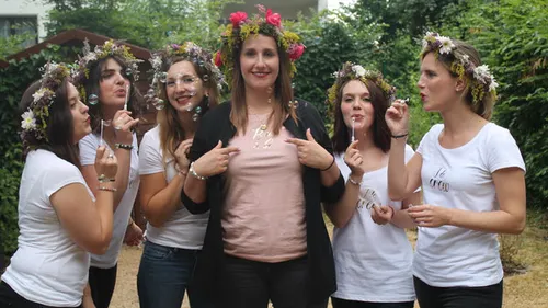 Women blowing bubbles in a garden setting.