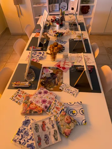 Art supplies on a long table, cozy room.