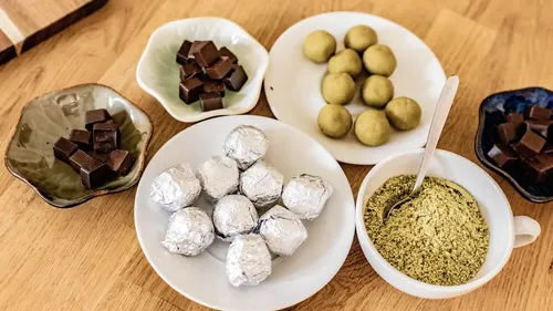 Assorted chocolates and truffles on plates.