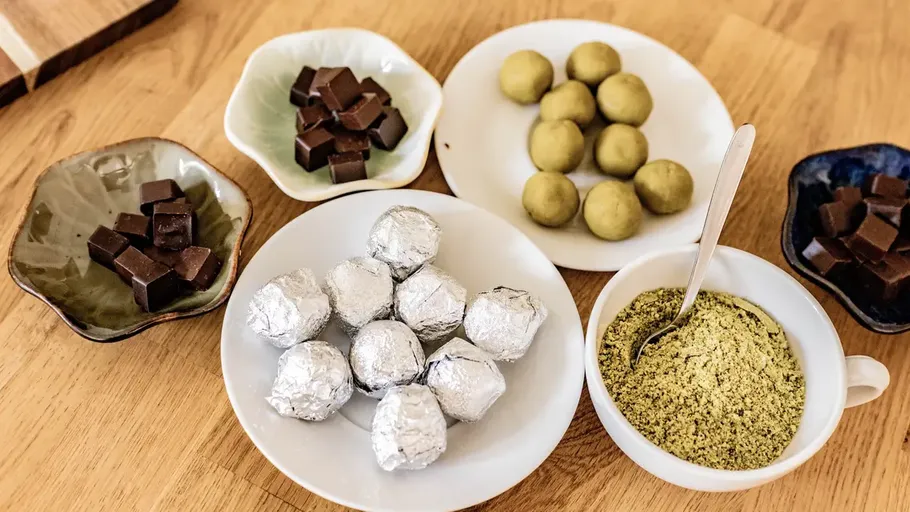 Assorted chocolates and truffles on plates.